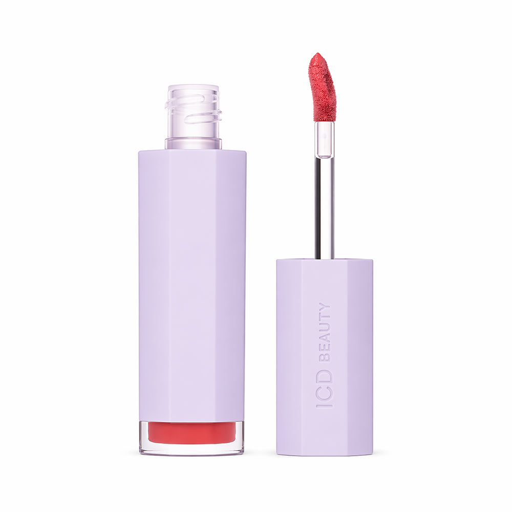 Lip gloss with purple case and red lip color on a white background