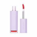 Lip gloss with purple case and red lip color on a white background