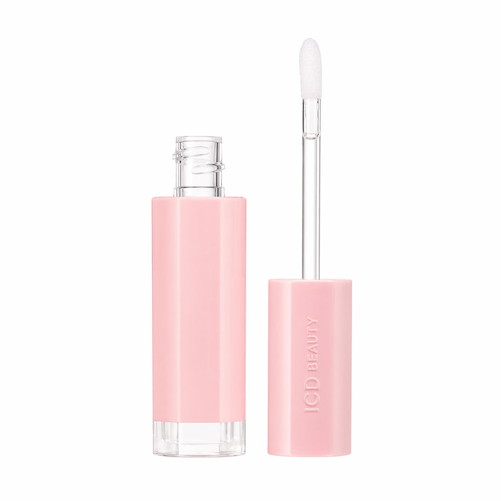 Pink lip gloss with applicator on a white background
