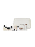 Cosmetic set with various skincare products and a white pouch on a white background